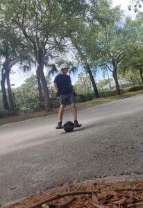 Prahlad Delaney riding his OneWheel electric skateboard in Florida
